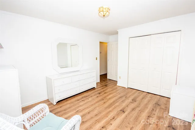 a view of a room with wooden floor and cabinet