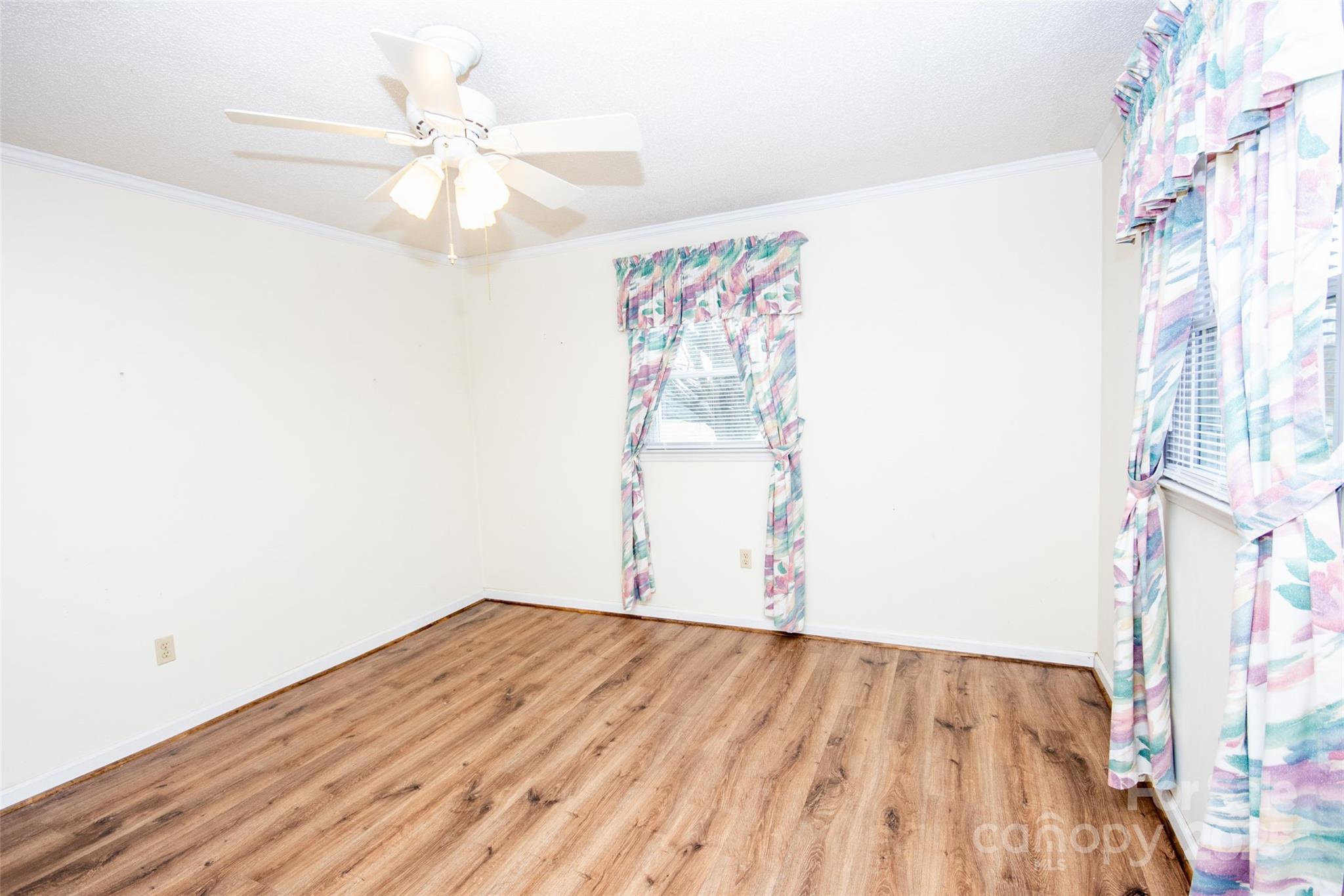 2890 Hobson Road Cleveland, NC 27013 - Photo 22 of 48 a view of a room with wooden floor and ceiling fan