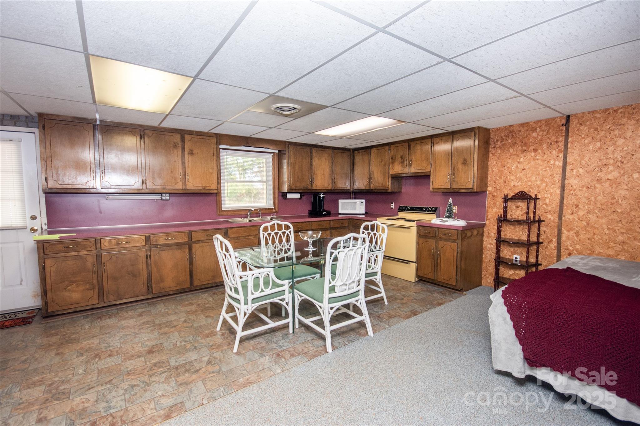 2890 Hobson Road Cleveland, NC 27013 - Photo 26 of 48 a kitchen with a table chairs microwave and cabinets
