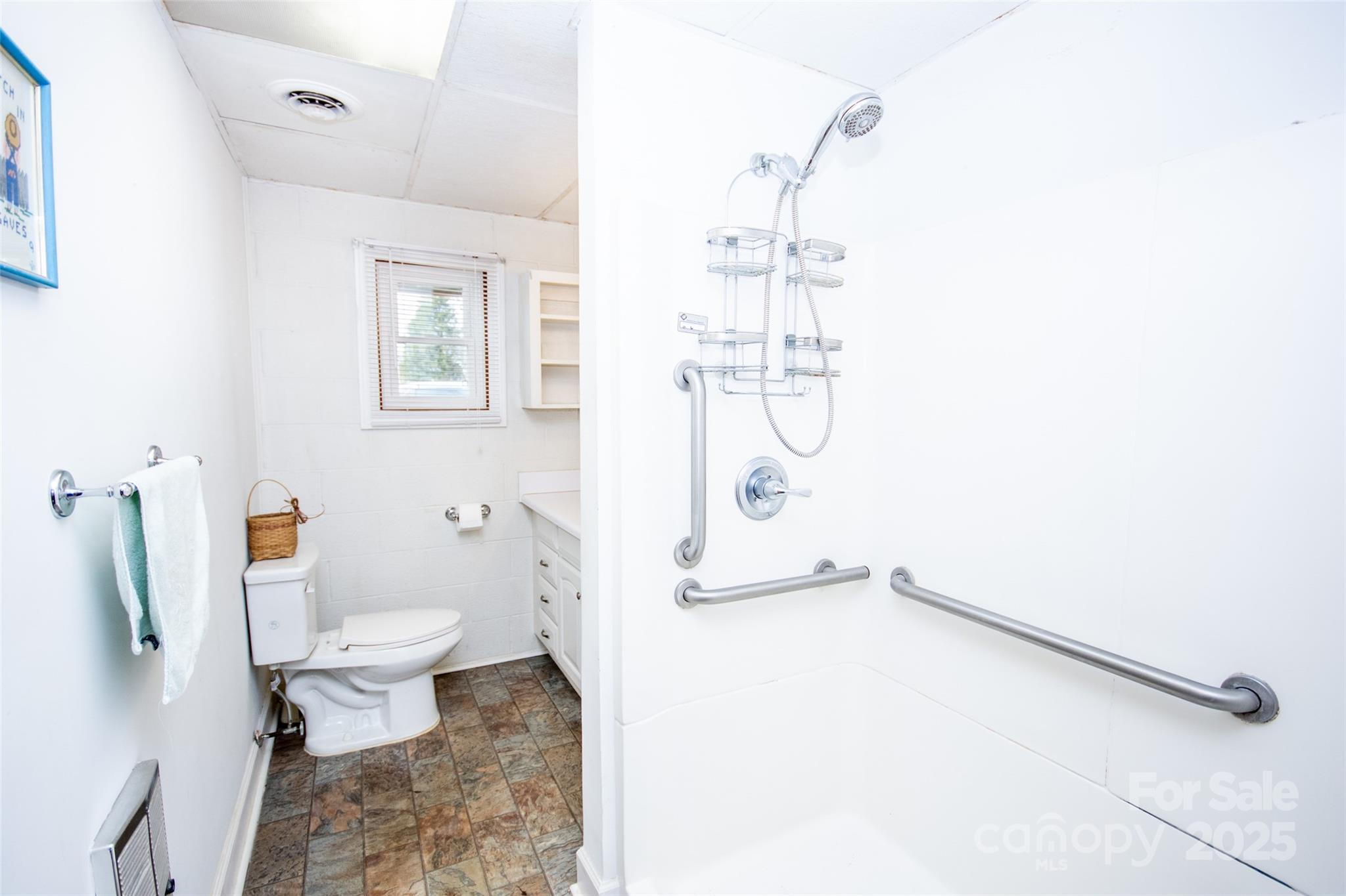 2890 Hobson Road Cleveland, NC 27013 - Photo 27 of 48 a bathroom with a granite countertop sink a toilet and a shower