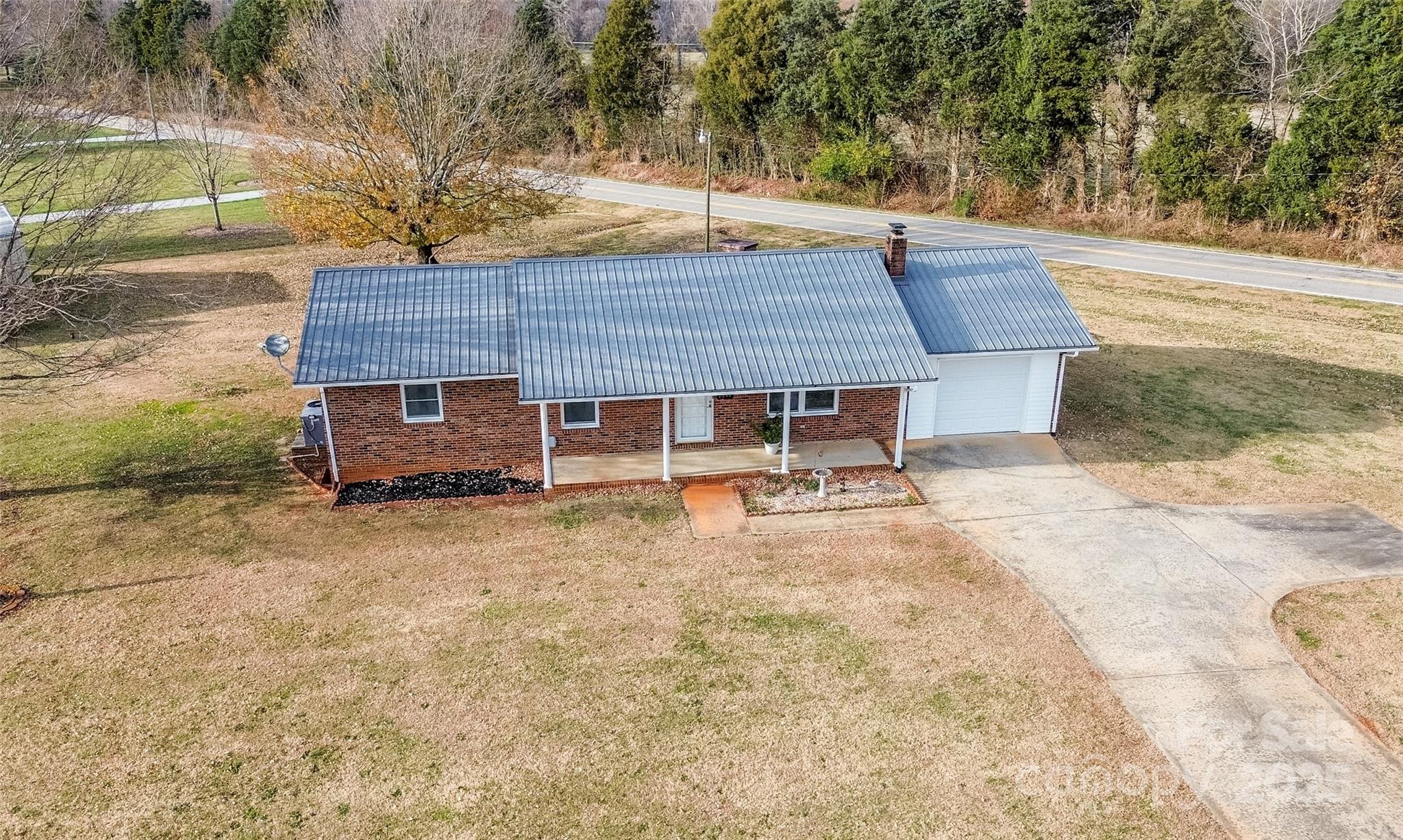 2890 Hobson Road Cleveland, NC 27013 - Photo 32 of 48 a backyard of a house with table and chairs
