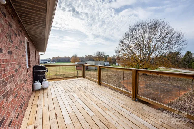 a view of balcony with wooden floor and fence