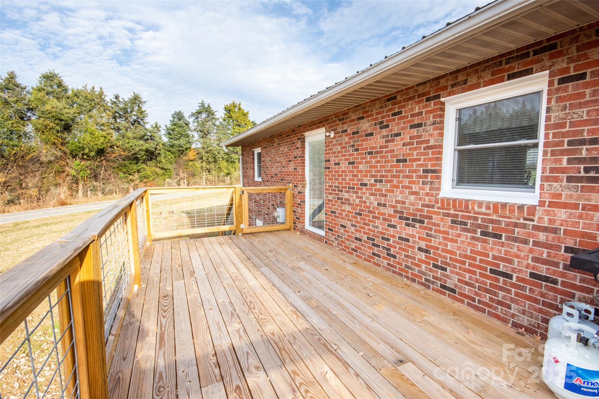 2890 Hobson Road Cleveland, NC 27013 - Photo 8 of 48 a view of a balcony with wooden floor and outdoor space