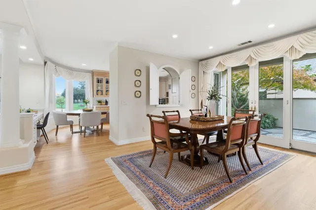 a kitchen with white cabinets and sink