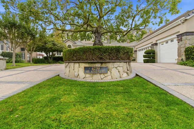 a living room with furniture large window and a fireplace