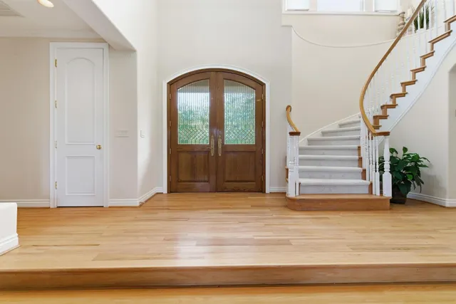 a living room with furniture large window and fireplace