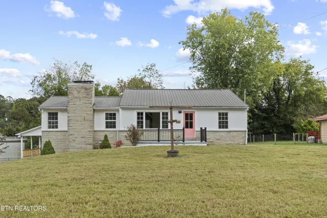 a house view with a sitting space and garden
