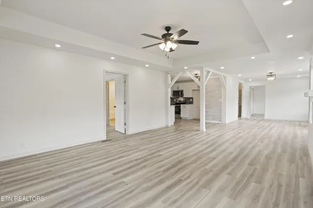 wooden floor in an empty room with a fan