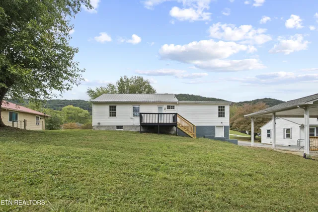 a view of a yard with a house in the background