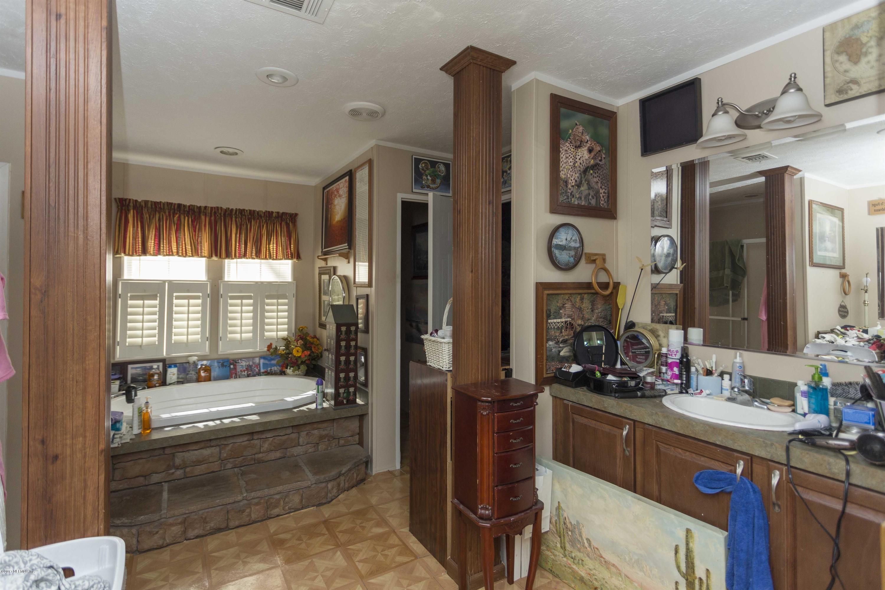 4049 Bronco Road Middleburg, FL 32068 - Photo 12 of 21 a bathroom with a granite countertop tub sink and mirror