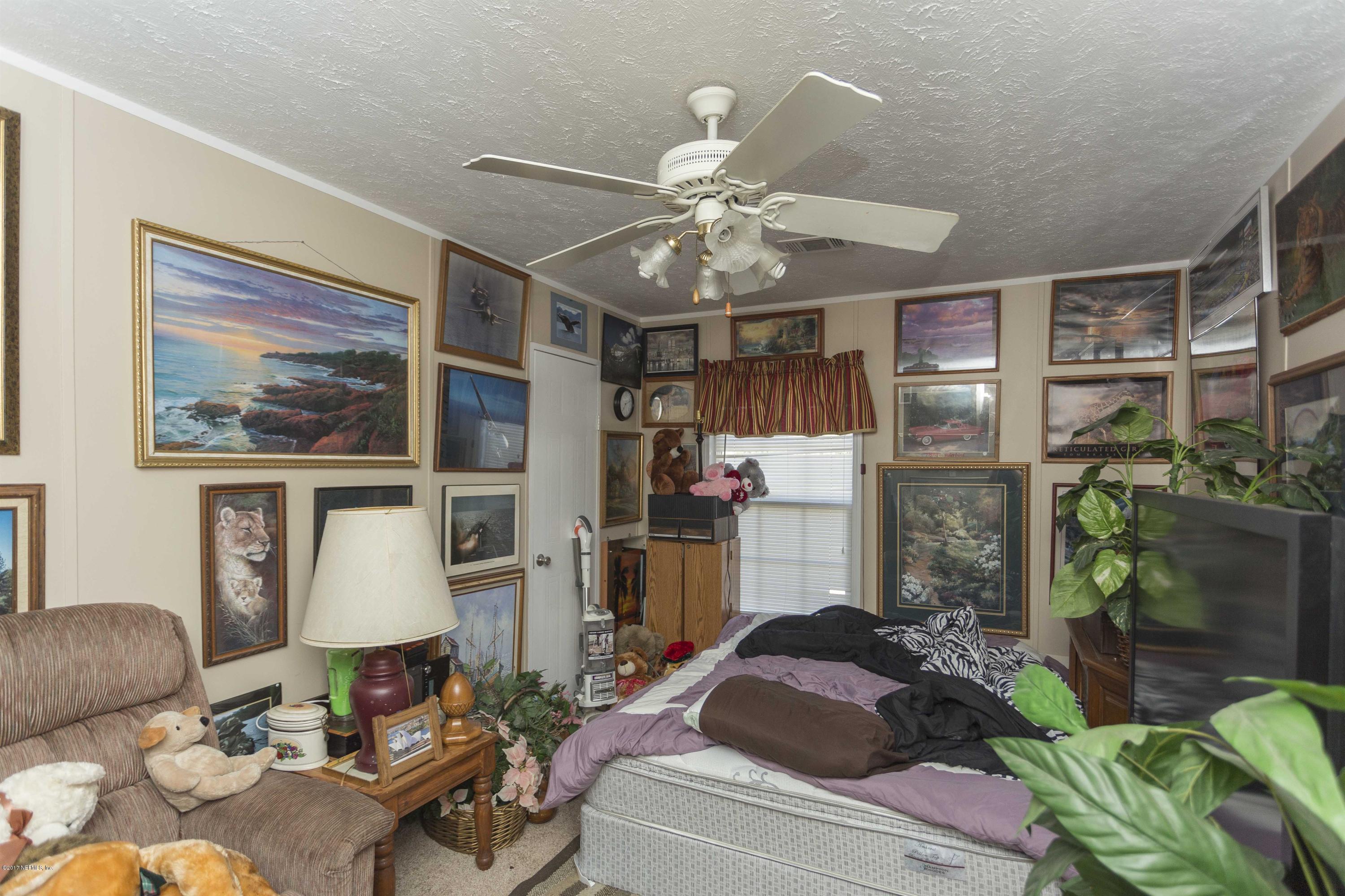 4049 Bronco Road Middleburg, FL 32068 - Photo 16 of 21 a living room with furniture and a floor to ceiling window