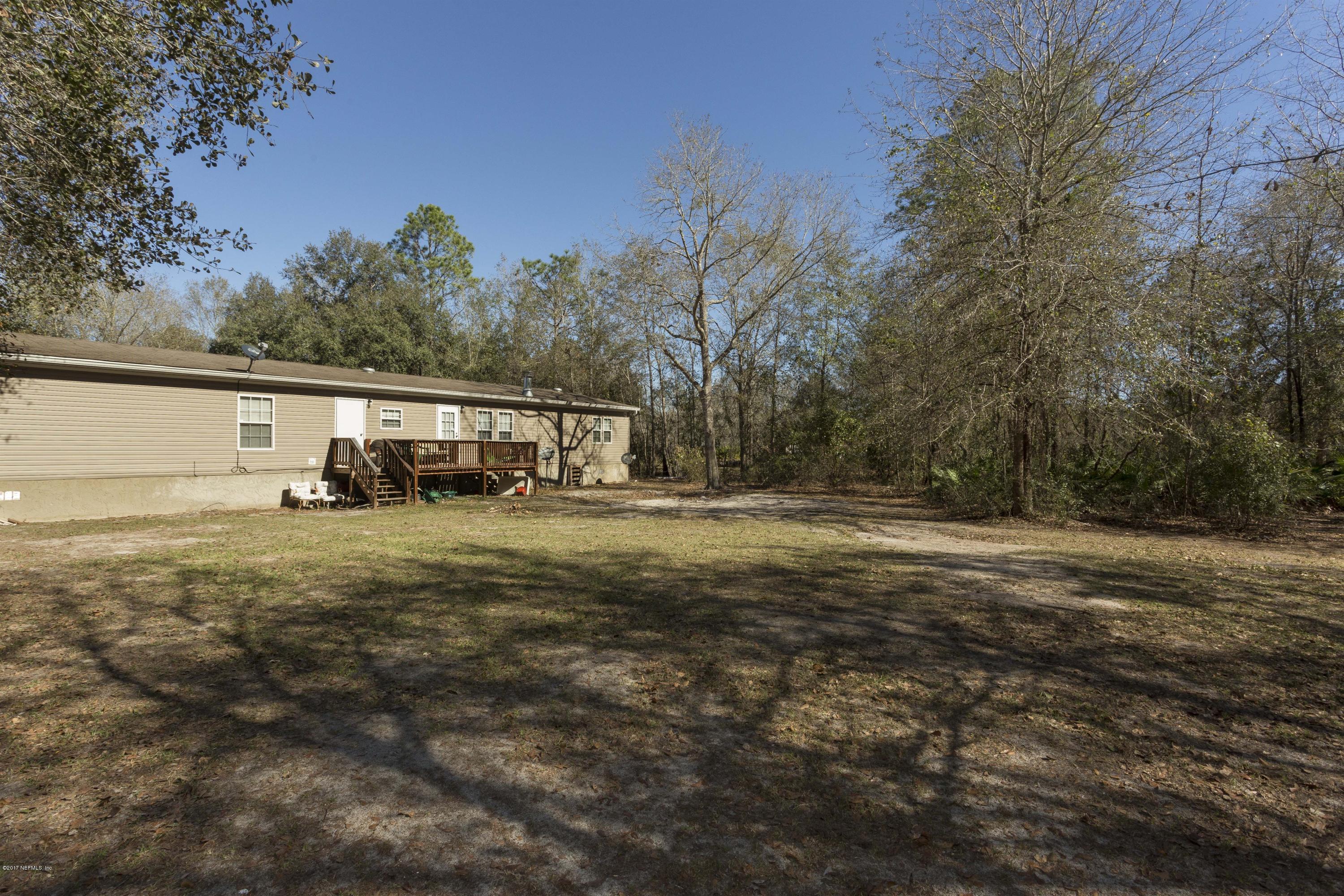 4049 Bronco Road Middleburg, FL 32068 - Photo 19 of 21 a view of house with outdoor space and trees in the background