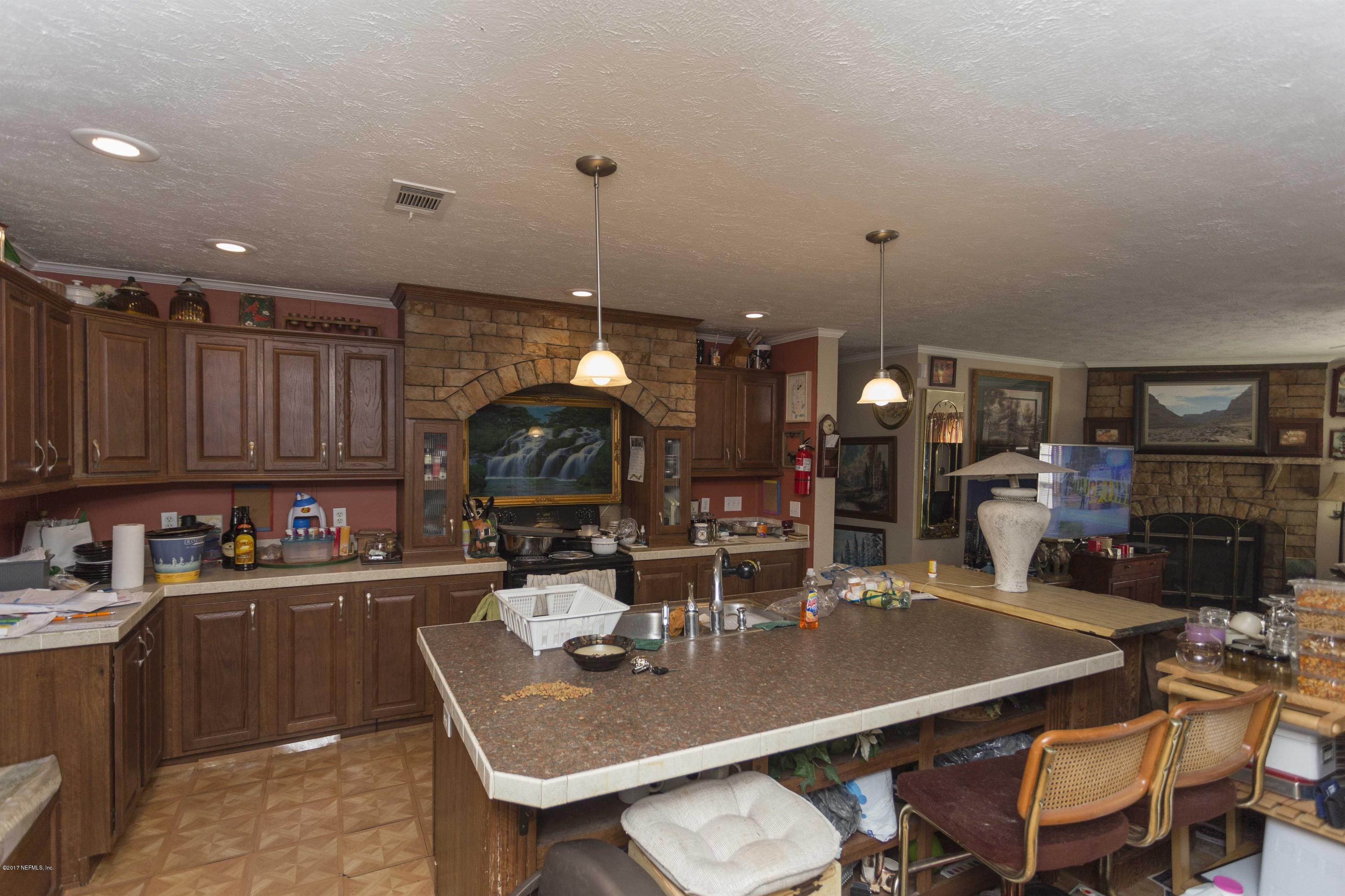 4049 Bronco Road Middleburg, FL 32068 - Photo 3 of 21 a kitchen with a table chairs and a refrigerator