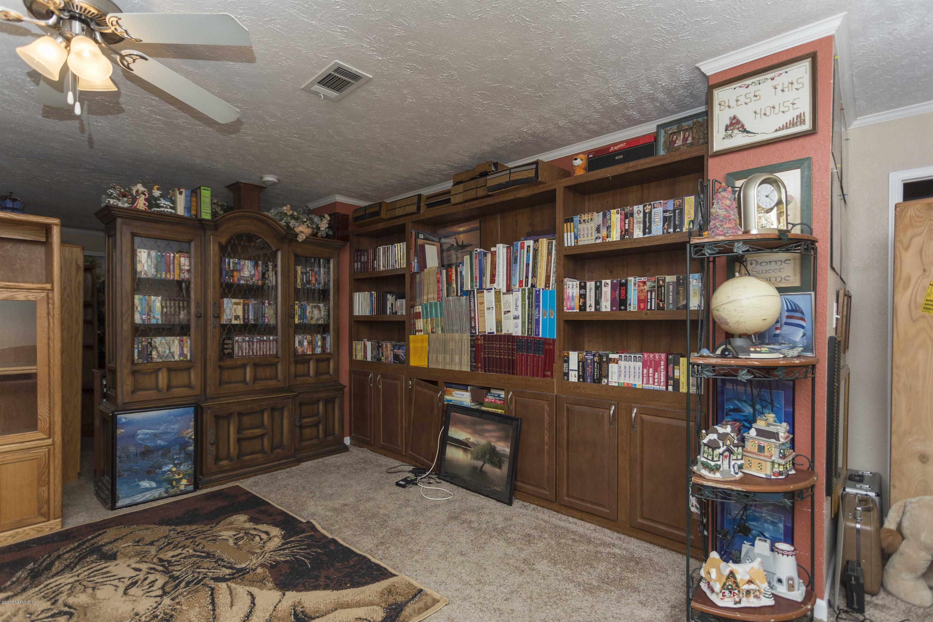 4049 Bronco Road Middleburg, FL 32068 - Photo 5 of 21 a room with furniture and wooden floor