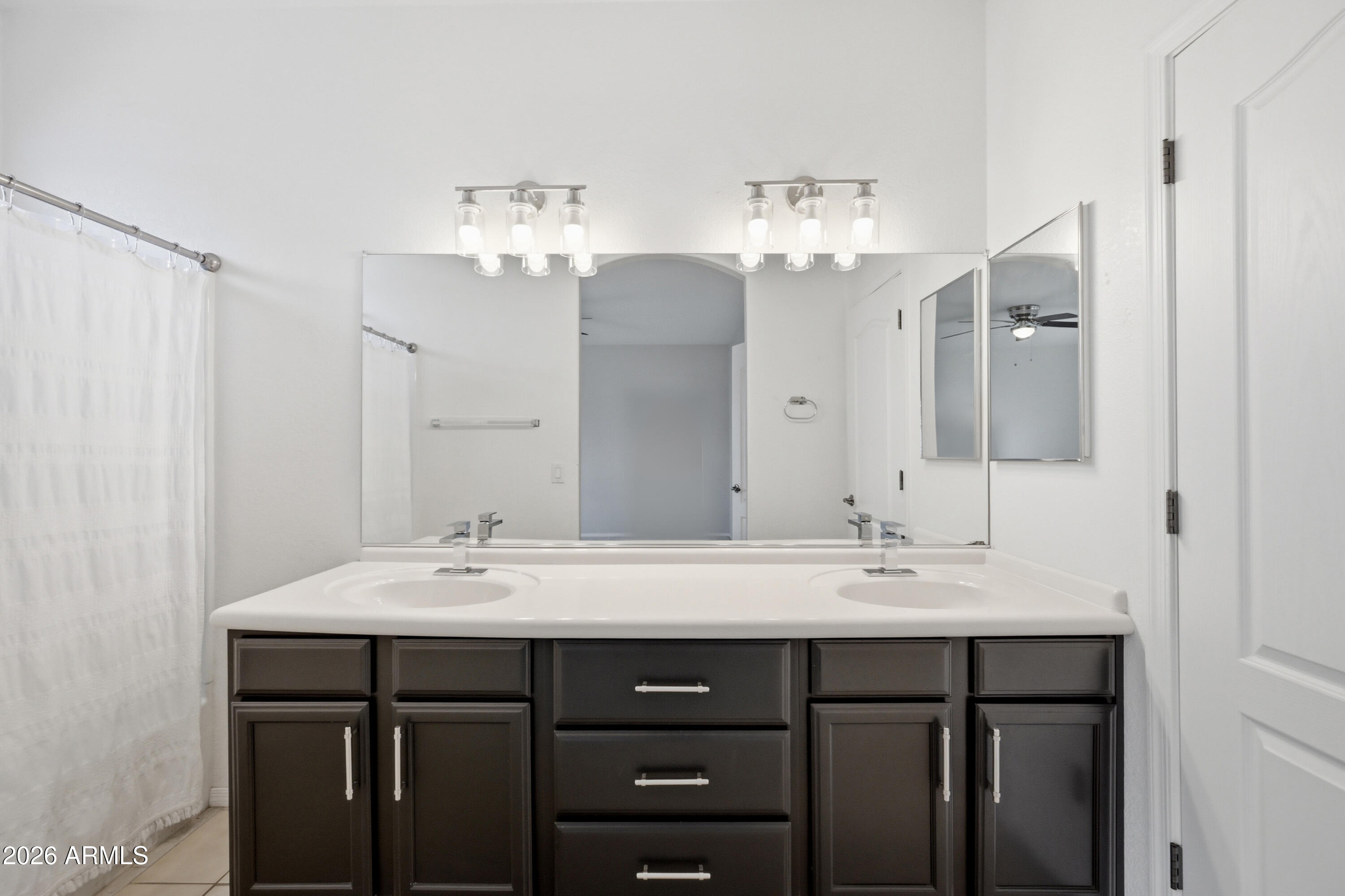 3150 East Beardsley Road, Unit 1009 Phoenix, AZ 85050 - Photo 26 of 31 a bathroom with a double vanity sink and a mirror