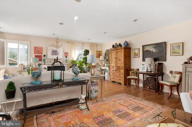 a living room with furniture a rug and a table
