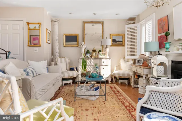 a living room with furniture a rug and a floor to ceiling window