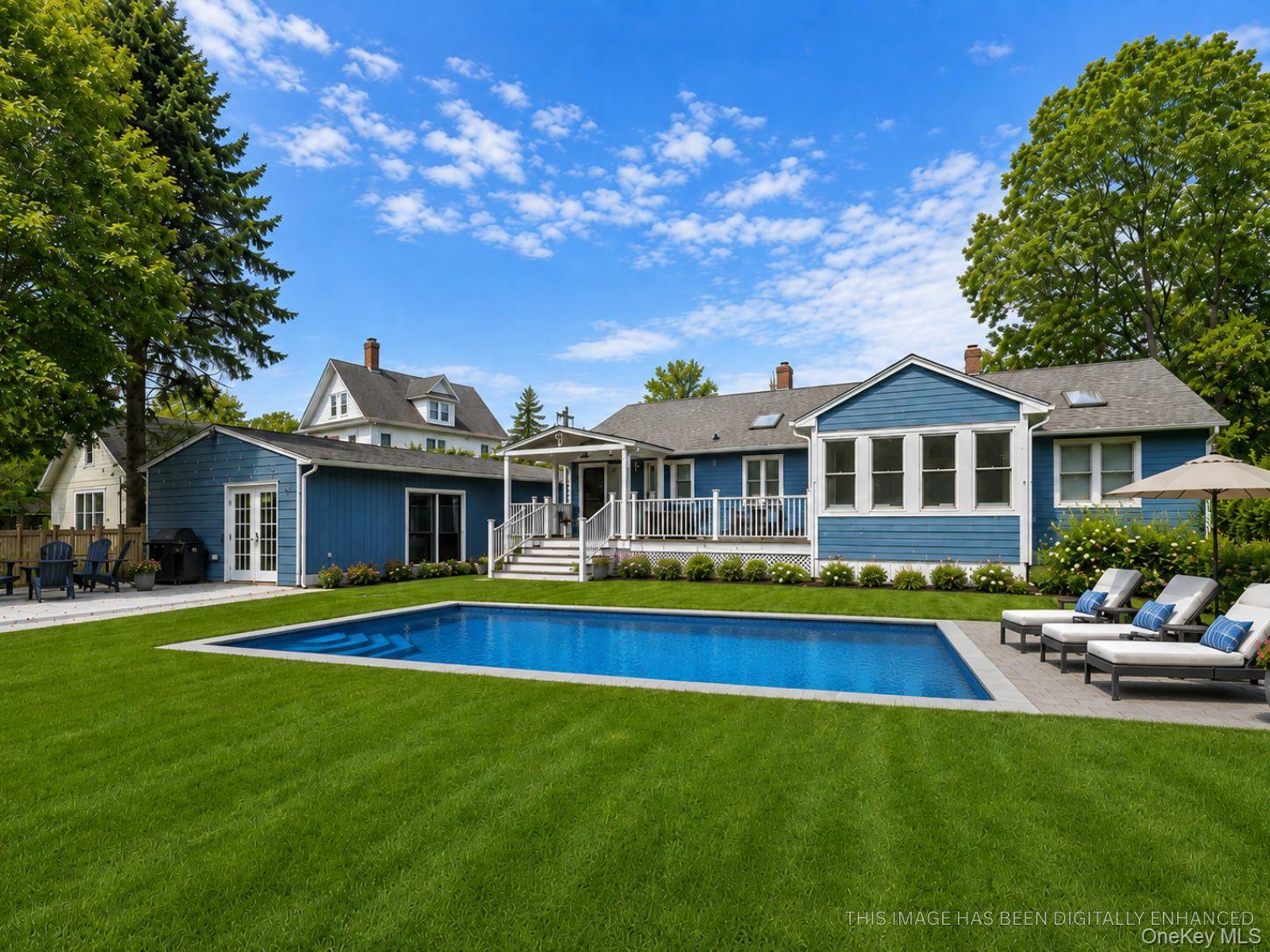 a front view of a house with swimming pool having outdoor seating