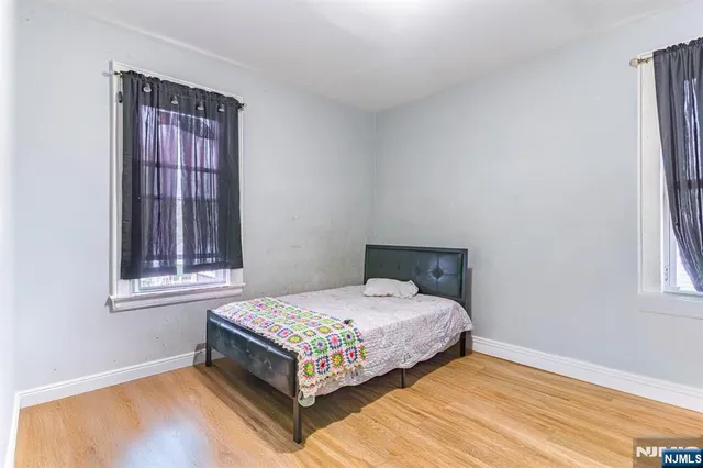 a bedroom with a bed table and window
