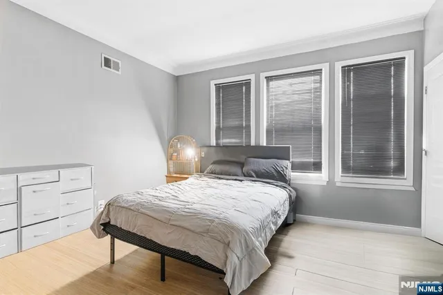 a bedroom with a bed a window and walk in closet