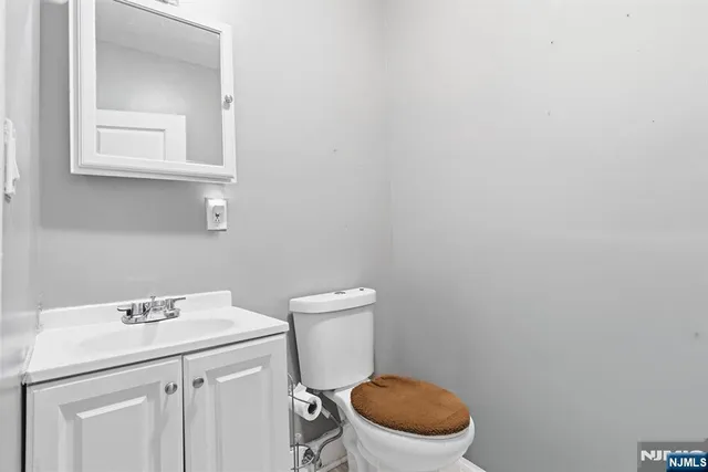 a bathroom with a sink a toilet and a mirror