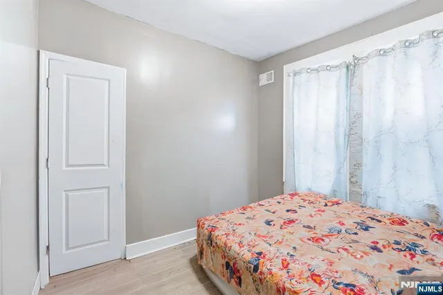 a bedroom with a bed and a curtain