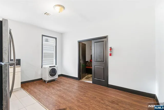 a kitchen with stainless steel appliances granite countertop a refrigerator a stove a sink and a window