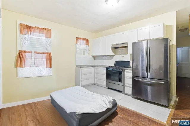 a kitchen with stainless steel appliances granite countertop a refrigerator sink and microwave