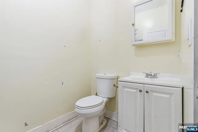 a bathroom with a sink a toilet and mirror