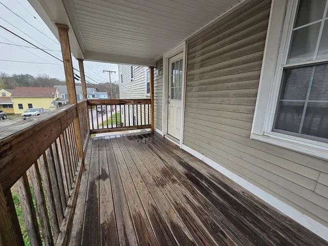 a view of a balcony with wooden floor