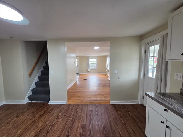 a view of entryway and hall with wooden floor