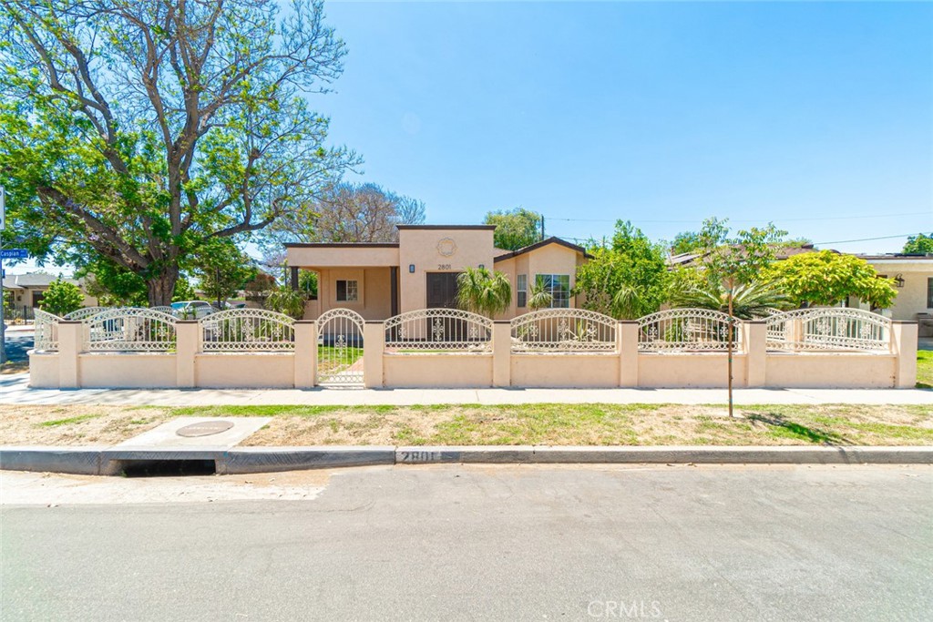 a front view of a house with a yard and swimming pool
