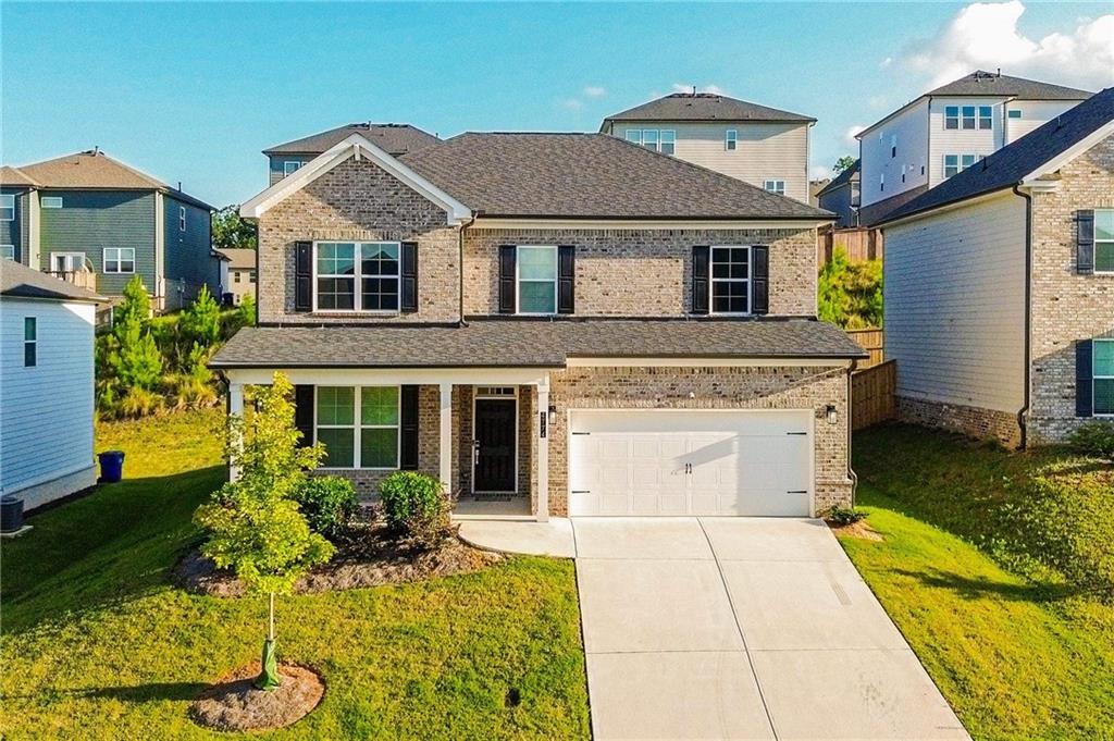 a front view of a house with garden