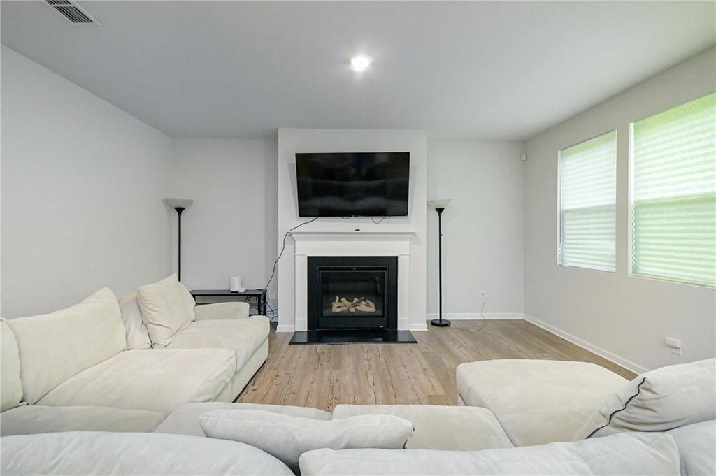 4774 Mock Orange Street Atlanta, GA 30331 - Photo 14 of 29 a living room with furniture a flat screen tv and a fireplace