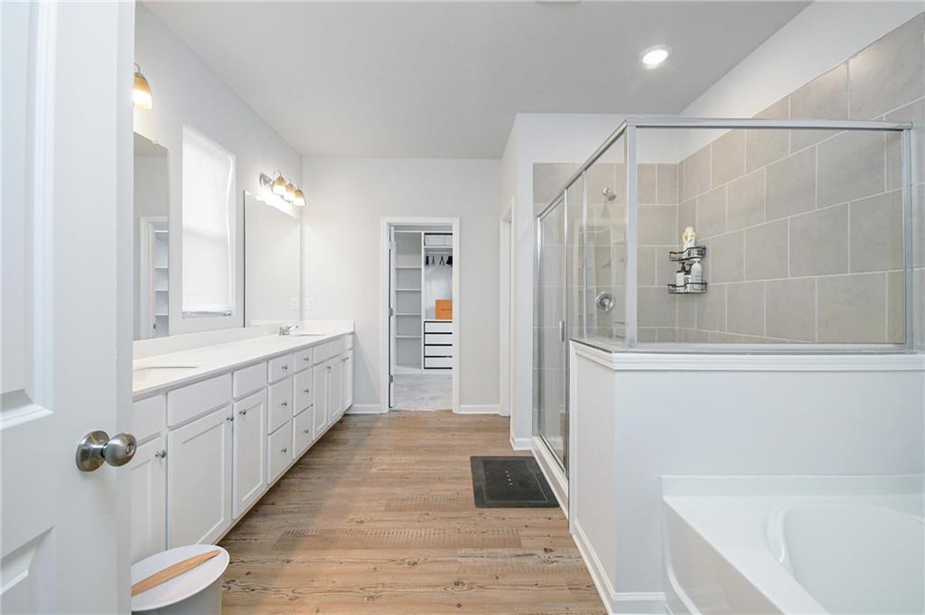 4774 Mock Orange Street Atlanta, GA 30331 - Photo 23 of 29 a bathroom with a tub sink shower and mirror