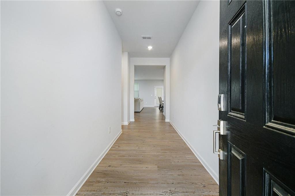 4774 Mock Orange Street Atlanta, GA 30331 - Photo 5 of 29 a view of a hallway with wooden floor and staircase