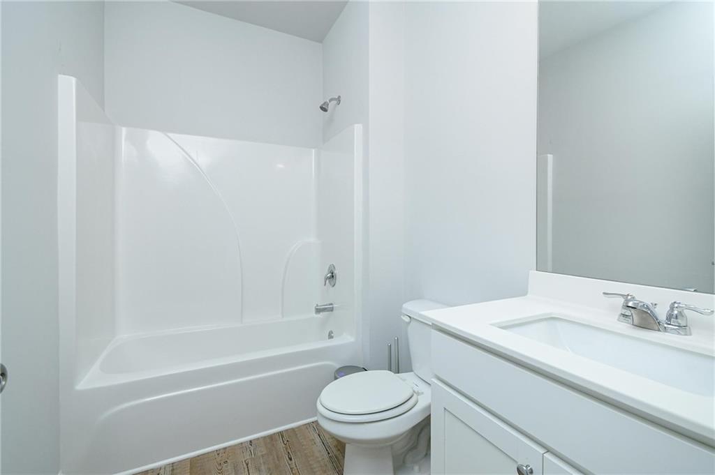 4774 Mock Orange Street Atlanta, GA 30331 - Photo 8 of 29 a bathroom with a granite countertop sink a toilet and a bathtub