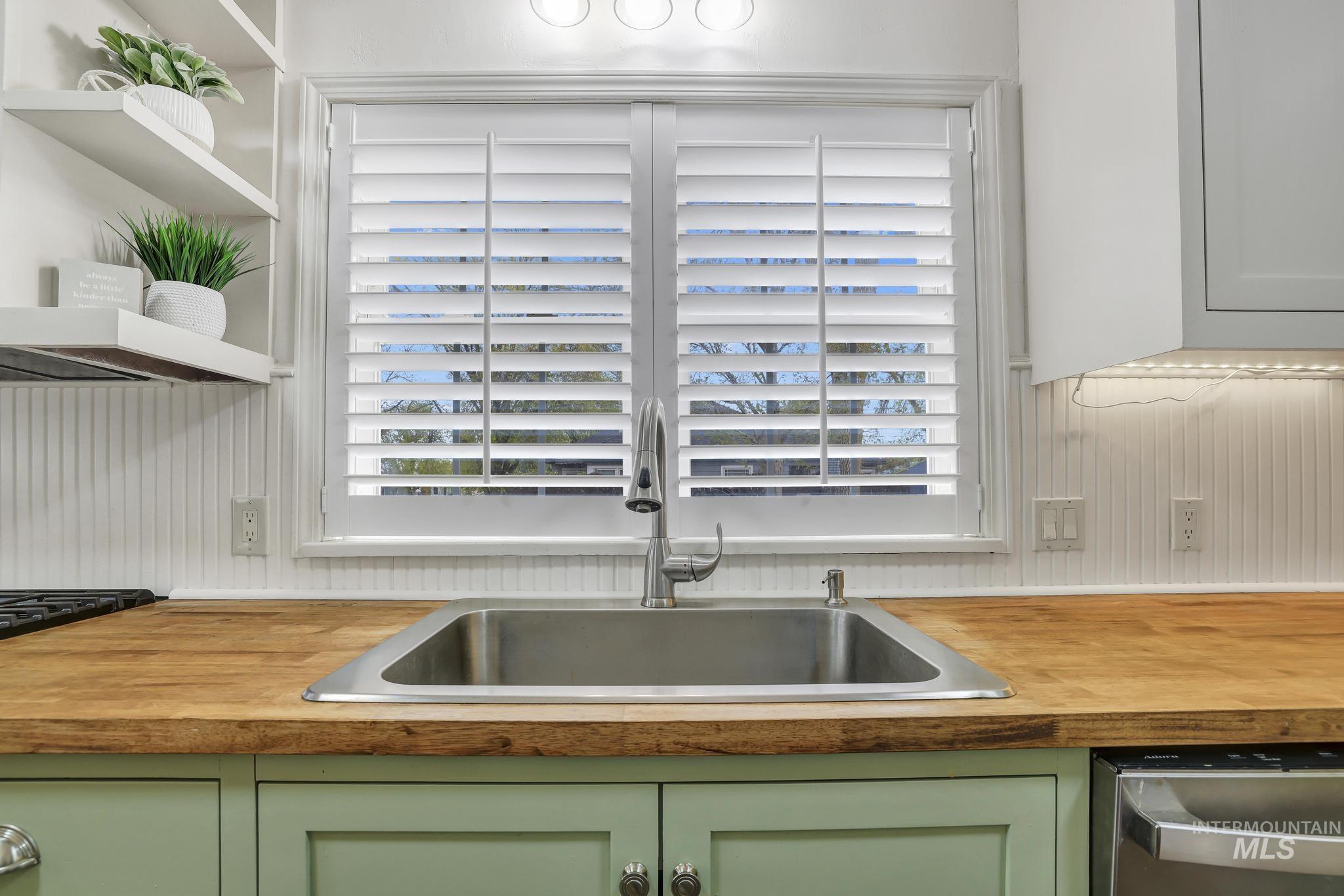 102 Fillmore Street Twin Falls, ID 83301 - Photo 16 of 48 Kitchen with green cabinetry, dishwasher, and open shelves