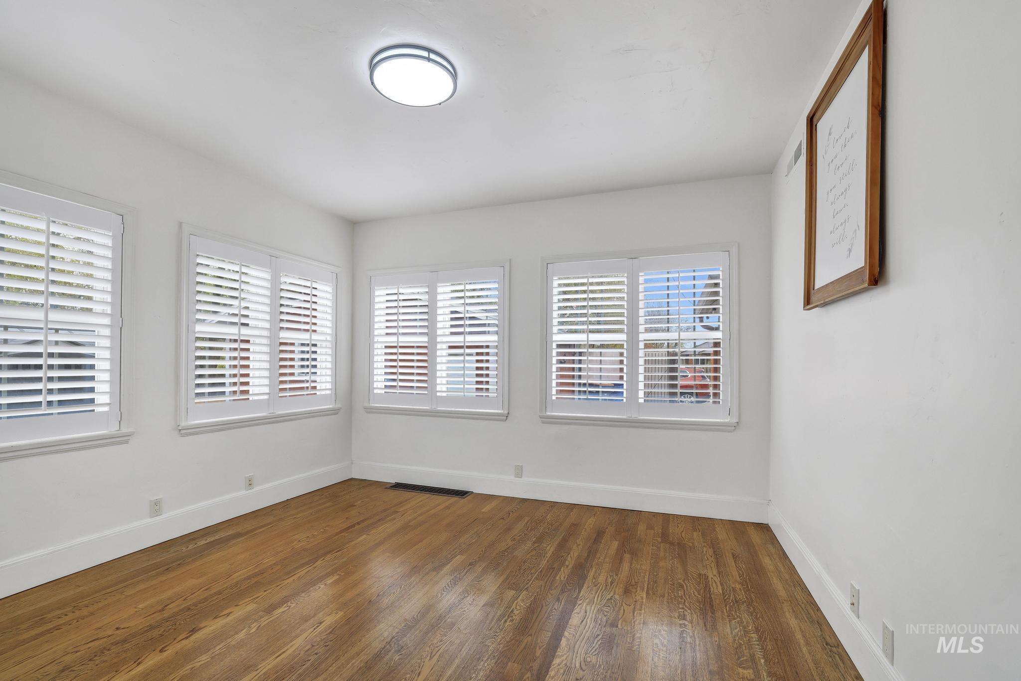 102 Fillmore Street Twin Falls, ID 83301 - Photo 22 of 48 Empty room featuring dark wood finished floors and baseboards