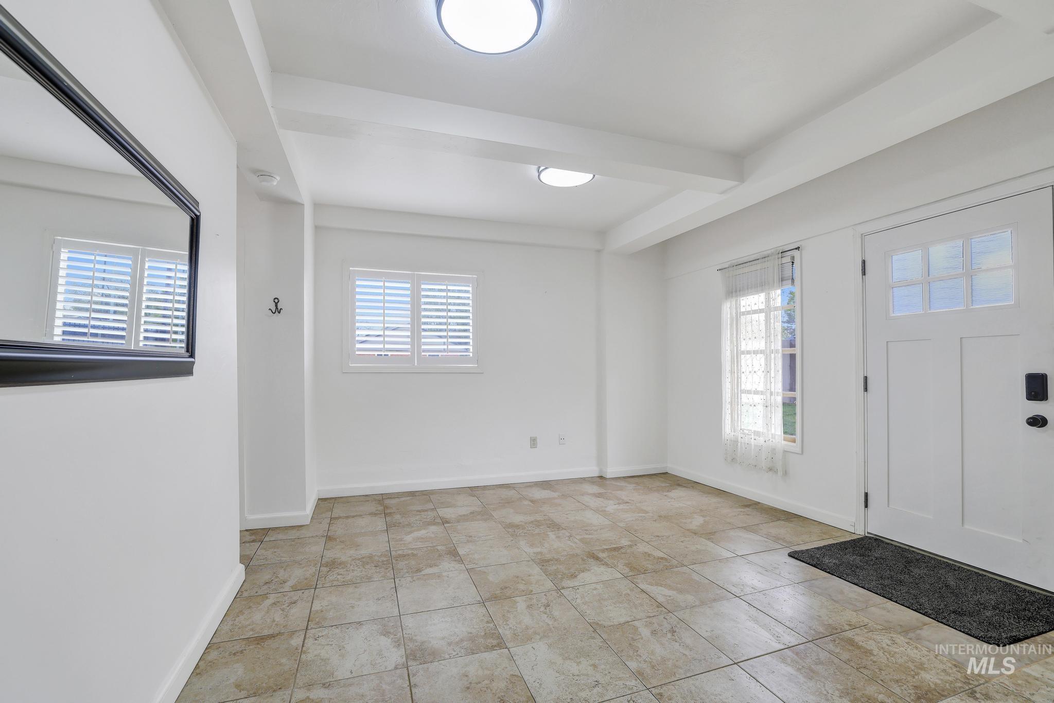 102 Fillmore Street Twin Falls, ID 83301 - Photo 24 of 48 Entrance foyer with plenty of natural light, beam ceiling, and light tile patterned floors