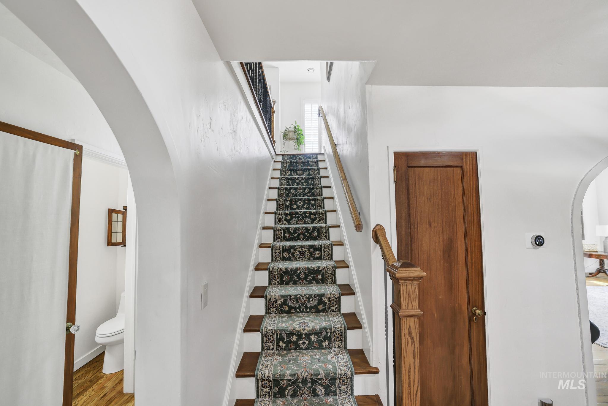 102 Fillmore Street Twin Falls, ID 83301 - Photo 27 of 48 Stairs featuring arched walkways and wood finished floors