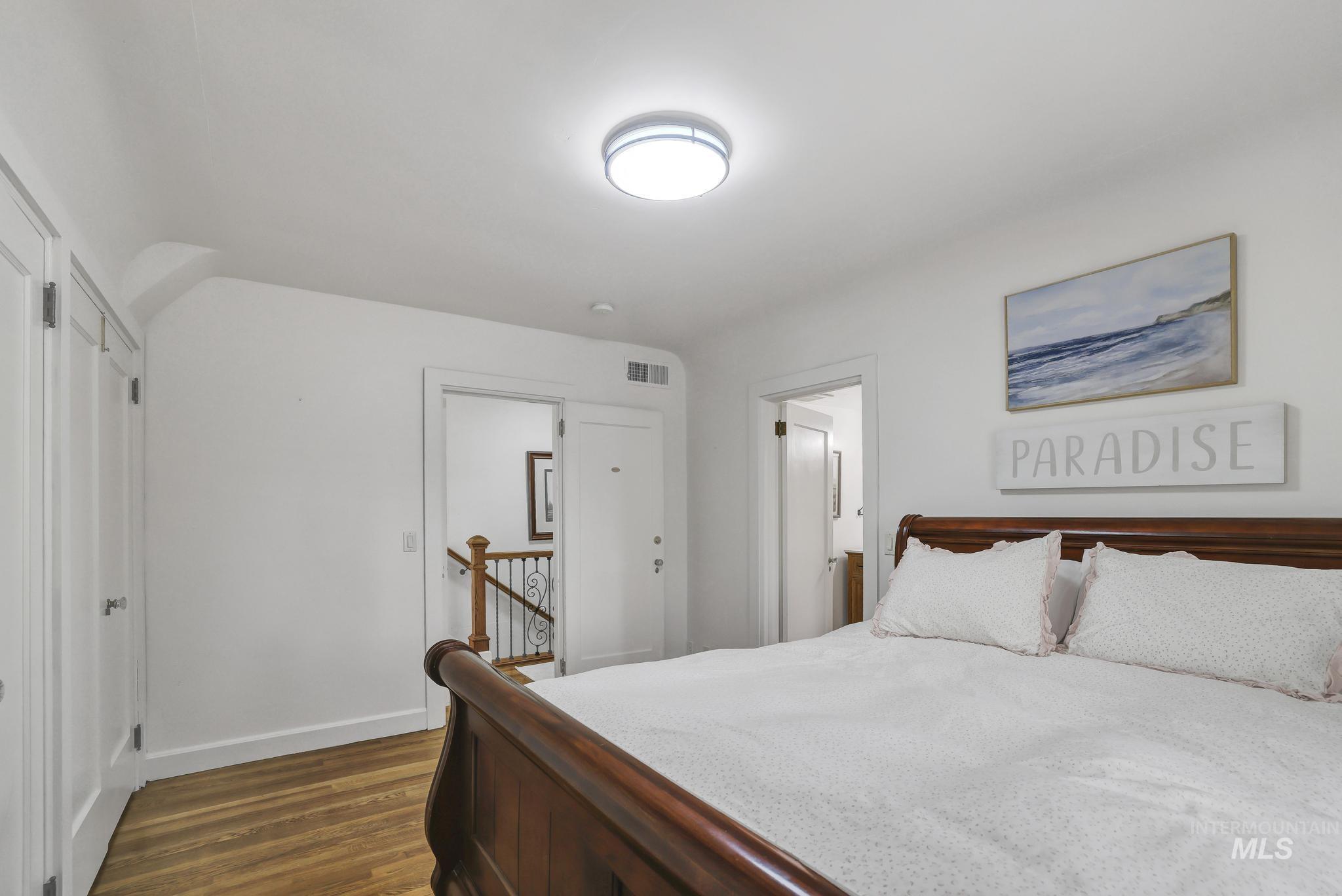 102 Fillmore Street Twin Falls, ID 83301 - Photo 30 of 48 Bedroom with dark wood-style flooring and ensuite bathroom