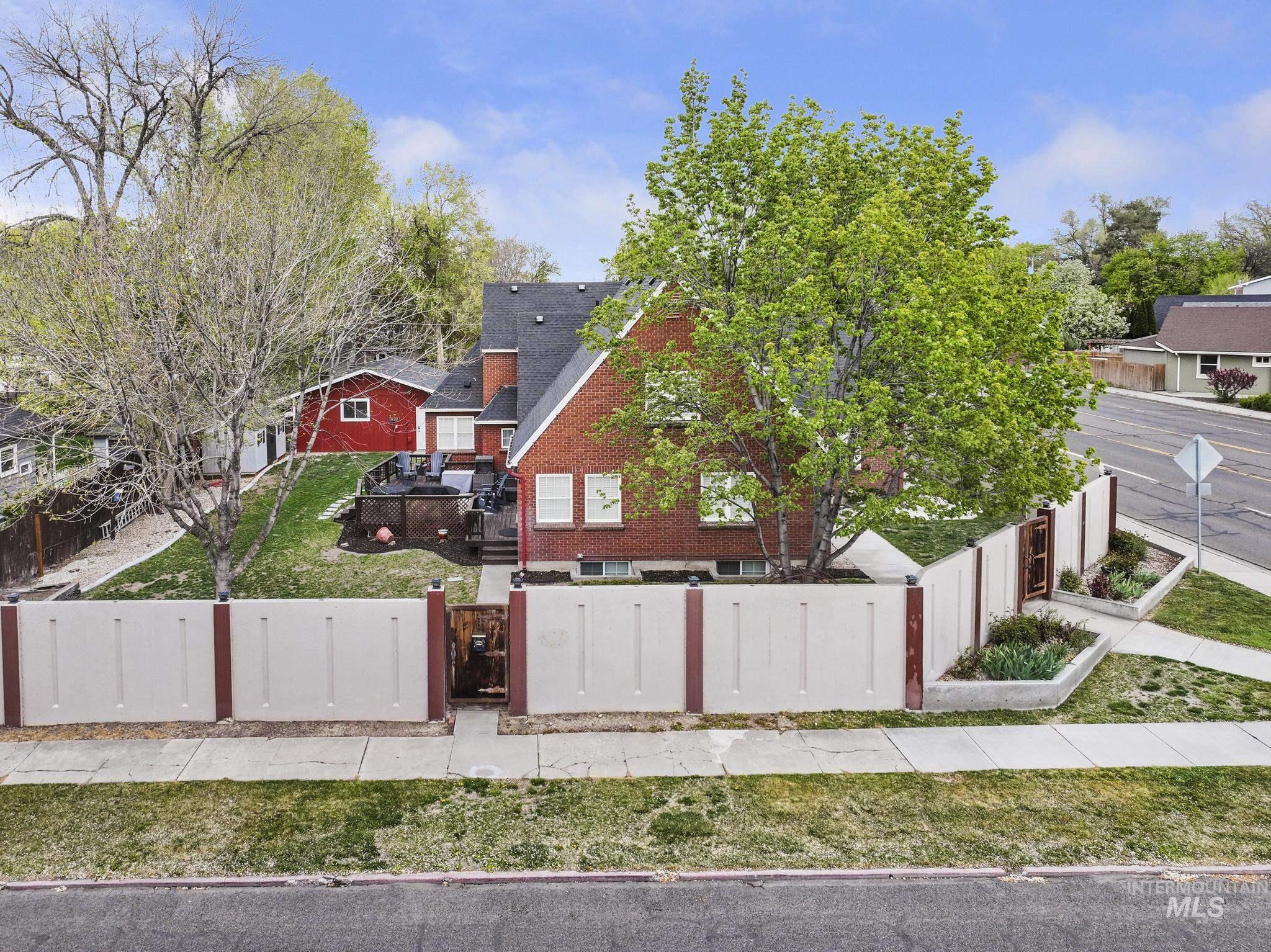 102 Fillmore Street Twin Falls, ID 83301 - Photo 3 of 48 View of front of property with a fenced front yard, brick siding, a gate, and a residential view