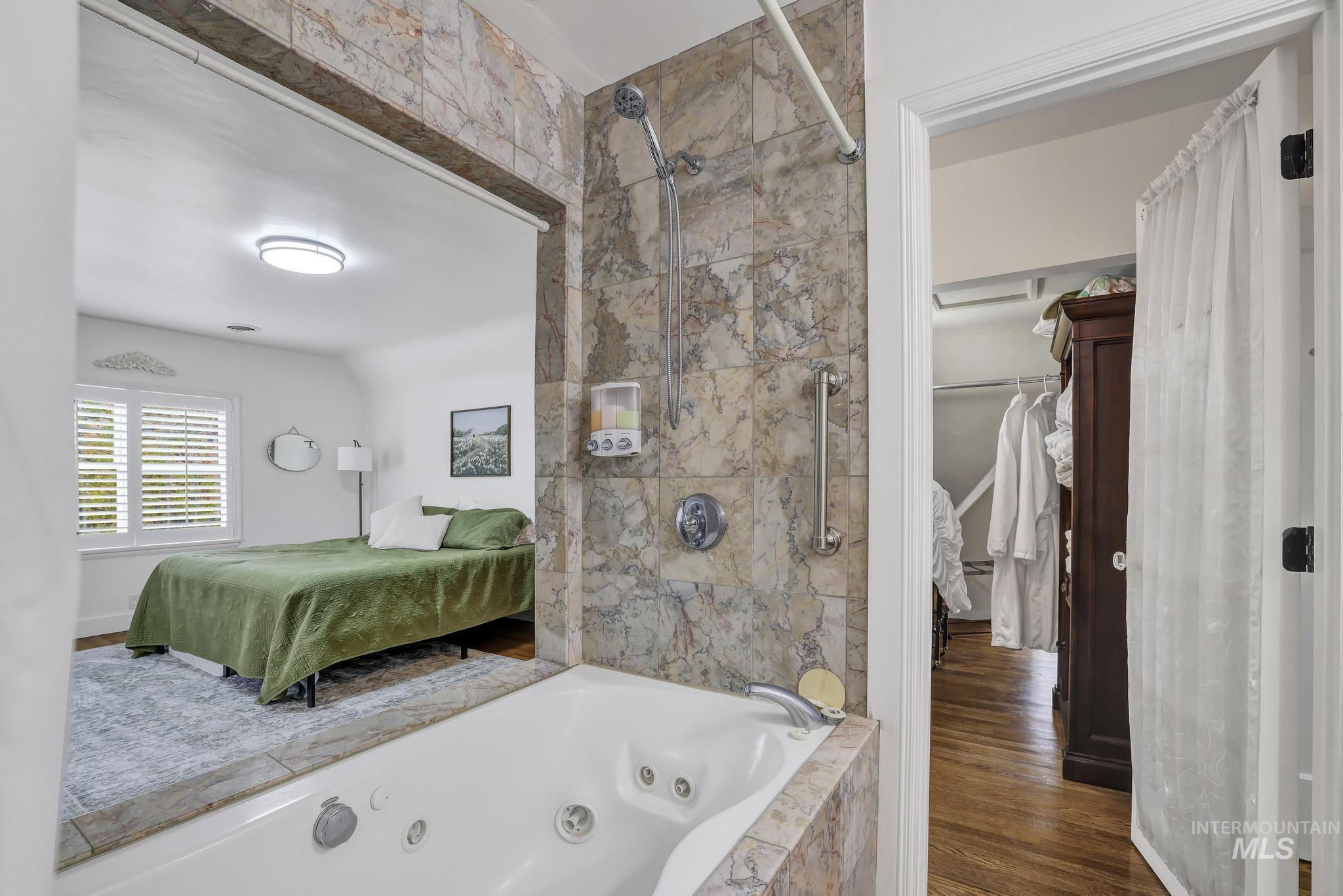 102 Fillmore Street Twin Falls, ID 83301 - Photo 36 of 48 Ensuite bathroom featuring a marble finish shower, a whirlpool tub, dark wood finished floors, and a walk in closet