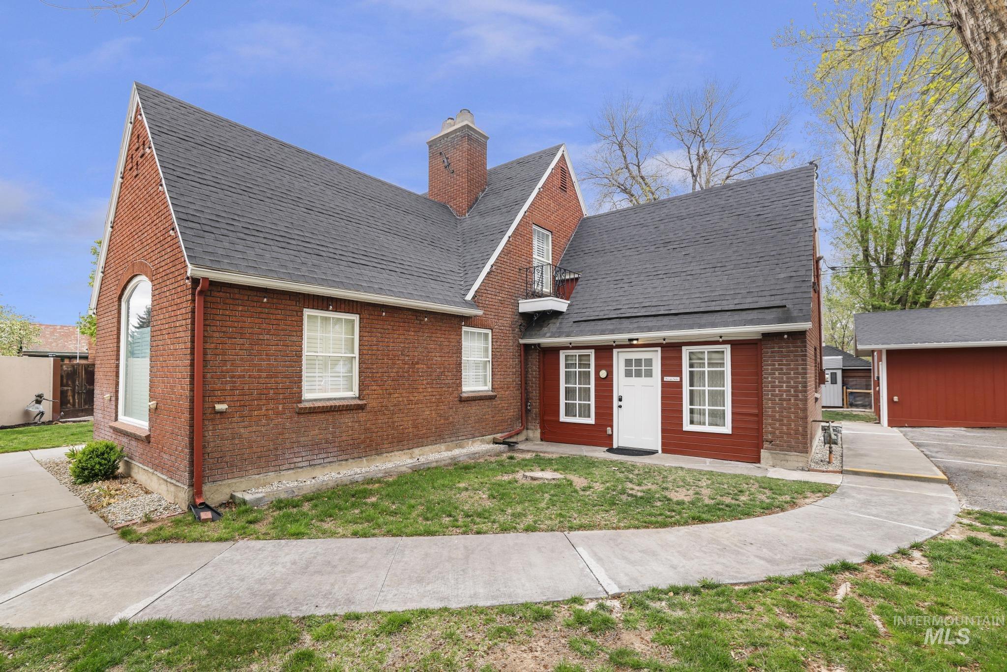 102 Fillmore Street Twin Falls, ID 83301 - Photo 39 of 48 View of front of property featuring brick siding, a front lawn, a chimney, and roof with shingles