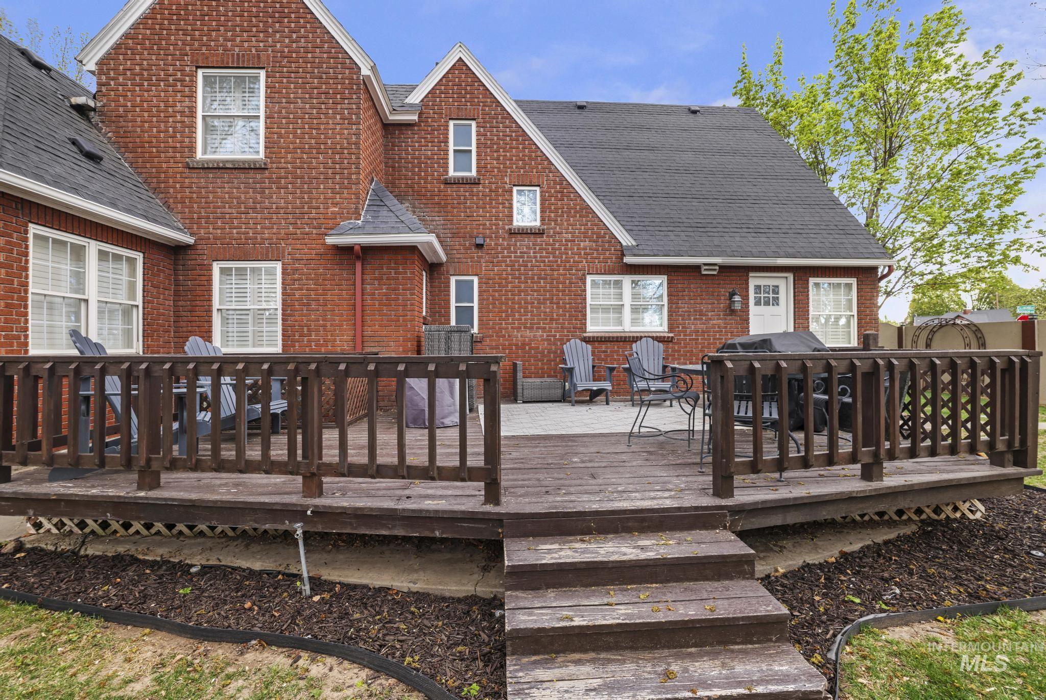 102 Fillmore Street Twin Falls, ID 83301 - Photo 42 of 50 Multi-level wooden deck with steps, featuring dark wood railing, and an adjoining stone patio