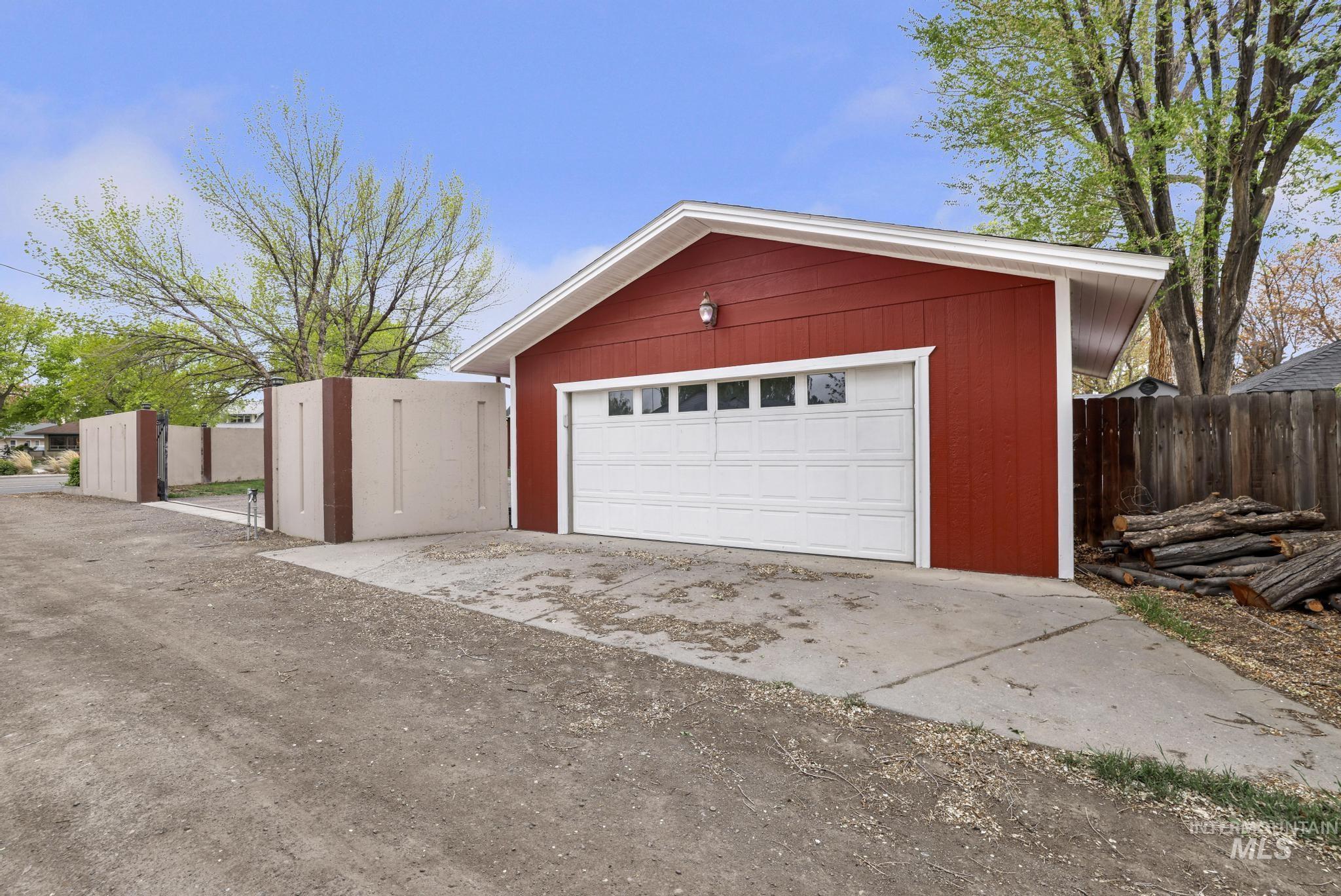 102 Fillmore Street Twin Falls, ID 83301 - Photo 44 of 49 Detached garage with red siding, white trim, and a paneled garage door with windows