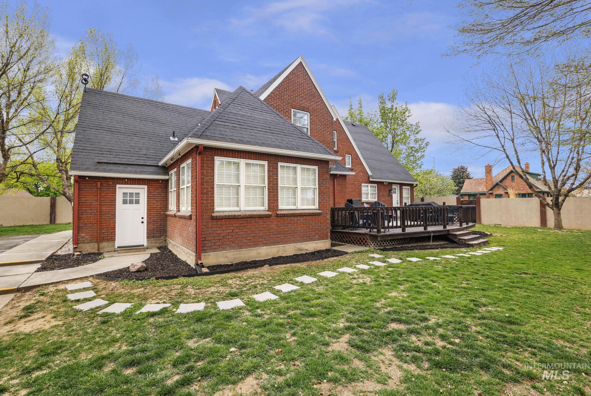 102 Fillmore Street Twin Falls, ID 83301 - Photo 5 of 48 Back of property with brick siding, a deck, and roof with shingles