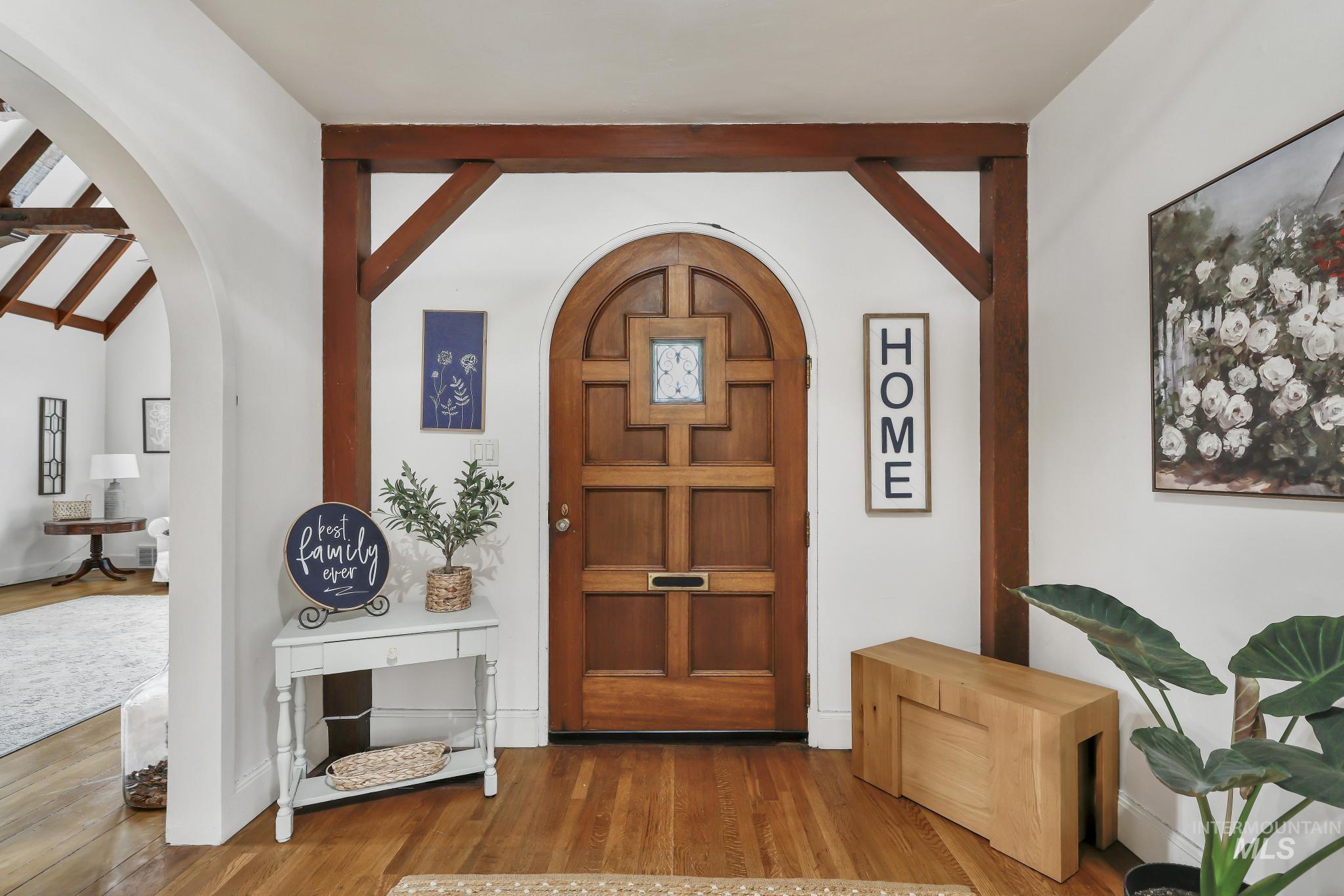 102 Fillmore Street Twin Falls, ID 83301 - Photo 9 of 48 Foyer entrance featuring wood finished floors, arched walkways, and lofted ceiling with beams