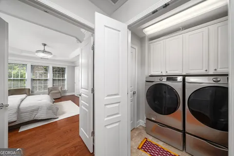 a view of a bedroom with washer and dryer